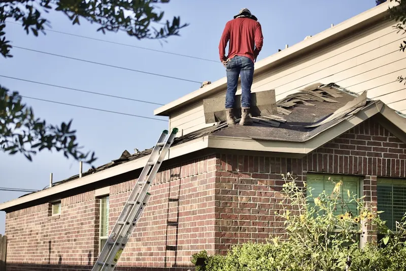 Professional roofer working on a residential roof in Highway Lake Estates